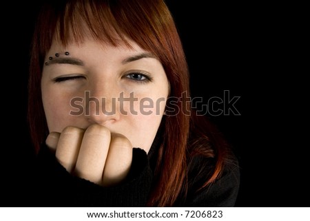 stock photo : Redhead girl with one eye closed. Lit with three flashes, hair