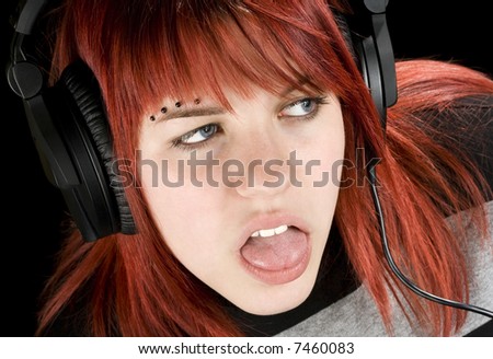stock photo A cute redhead girl expressing boredom while listening to 