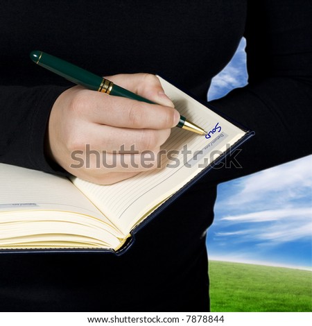 Concept shot of a hand noting that something was sold in a notebook.