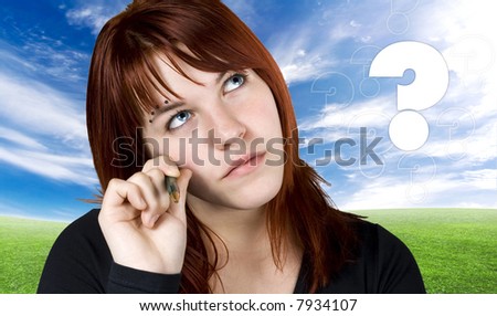 stock photo : Cute redhead girl with piercings looking up and thinking about 