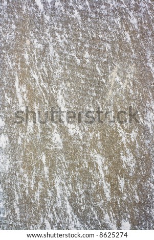 Texture of a wall with worn out spray stains.