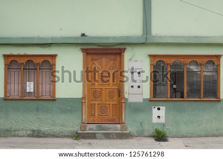 Old wooden Door windows Latin America green, electrical panel