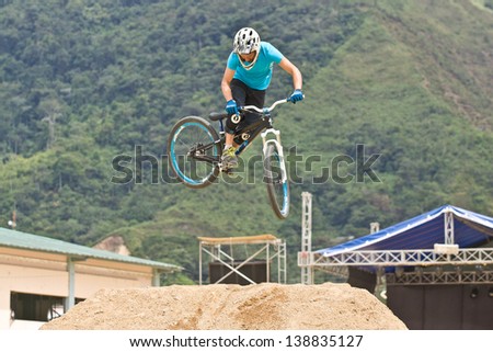 ZAMORA REGION, ZAMORA, ECUADOR-APRIL 27:Rider Juan Alfonso Reece does mountain bike jump tricks in Zamora, Ecuador on April 27, 2013. Extreme sports demonstrations were part of tourism conference.