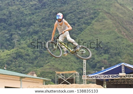 ZAMORA REGION, ZAMORA, ECUADOR-APRIL 27:Rider Luciano De Neufville does mountain bike jump tricks in Zamora, Ecuador on April 27, 2013. Extreme sports demonstrations were part of tourism conference.