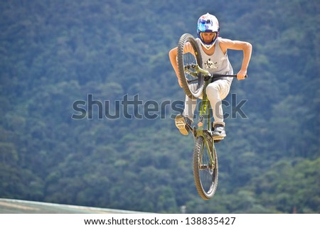 ZAMORA REGION, ZAMORA, ECUADOR-APRIL 27:Rider Luciano De Neufville does mountain bike jump tricks in Zamora, Ecuador on April 27, 2013. Extreme sports demonstrations were part of tourism conference.
