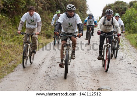 ZAMORA REGION, ECUADOR-JULY  13 2013:Riders  in the rain and mud in the Andes Mountains on July 13, 2013. Governments in Ecuador are actively promoting fitness activities.