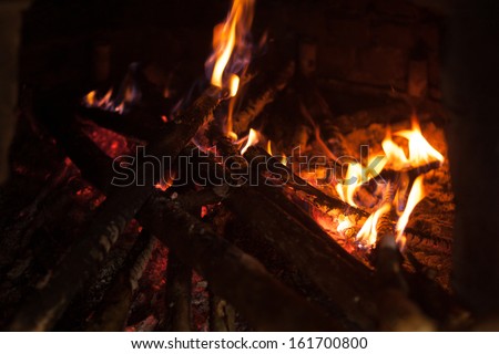 Traditional wood fired oven in the Andes region of Ecuador with flames and sticks