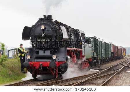 BEEKBERGEN, NETHERLANDS - MAY 19 , 2013: steam train from the Veluwsche steam train company  is driving into the historic railway station in Beekbergen in the Netherlands.