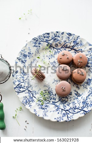 Dark chocolate and lavender macarons on vintage english plate
