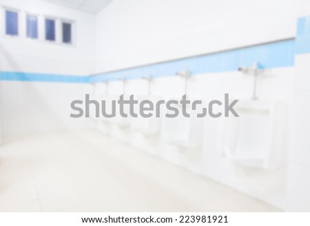 Blur Background Public Rest Room with Blue Strip on wall.