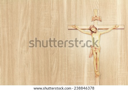 Vintage Jesus on cross put on wood background.