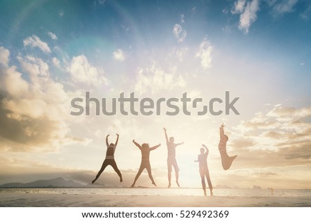 Silhouette of cheering young generation jumping on outdoor beautiful Rear view background. relax lifestyle hope faith love grow kid hands Happiness fitness exercising volleyball future party relation