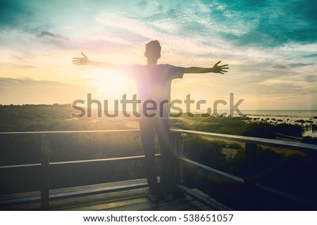 Silhouette man happy with hands rise up on beautiful. Christian praise on hill thanksgiving day background. Man consumed by wanderlust nature standing open arms enjoying sun concept fun wisdom modern