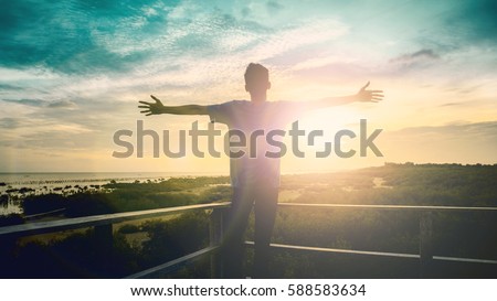 Silhouette man happy with hands rise up on beautiful. Christian praise on hill thanksgiving day background. Man consumed by wanderlust nature standing open arms enjoying sun concept fun wisdom modern
