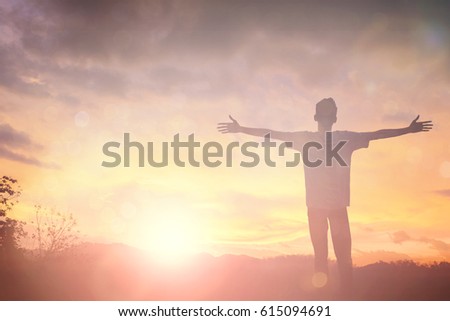 Silhouette man with hands rise up on beautiful view. Christian praise on hill thanksgiving day background.\
Man consumed by wanderlust nature standing open arms enjoying sun concept fun world wisdom