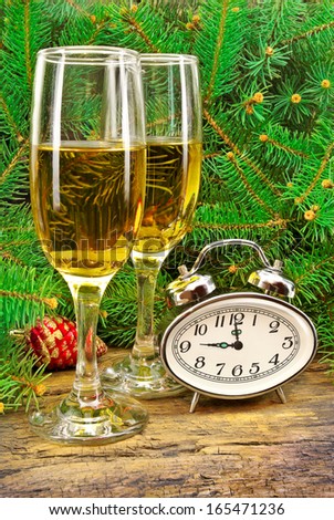 Wine glasses, watches, Christmas toys, near  New Year tree.