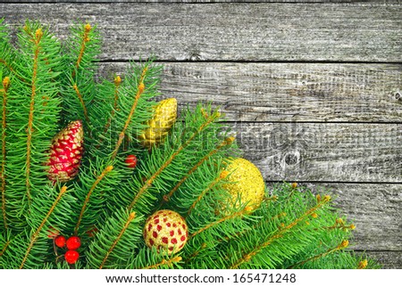 Christmas tree with a New Year toys on wood  texture.