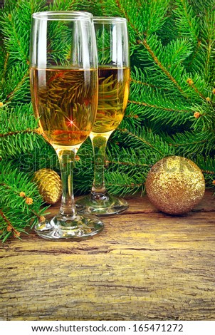 Wine glasses, Christmas toys, near  New Year tree.