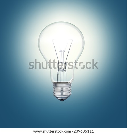 A light bulb shines in the darkness bright light
