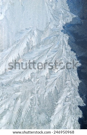 Frost patterns on a frozen window in winter.