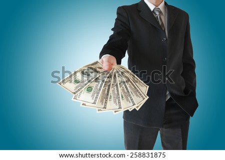 Man in  black suit offers money isolated on blue background.