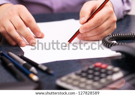 Businessman sitting at office desk and plans its work
