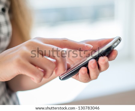 Young Beautiful Woman Writes An Sms To Your Mobile Phone