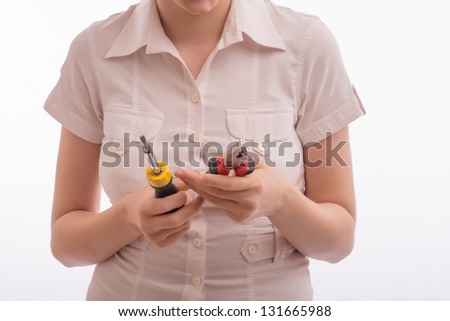 A woman with a screwdriver and pliers
