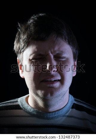 Businessman crying on a black background