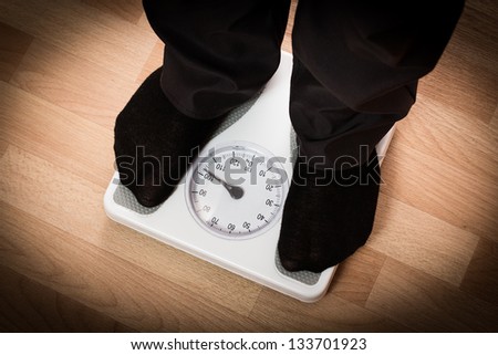 Overweight man on scales