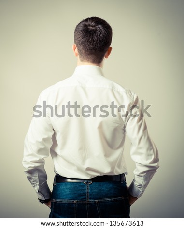 standing man back view on a gray background