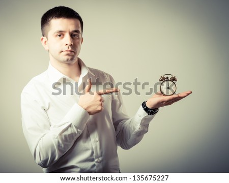 Alarm clock on businessman's hand, Time over concept