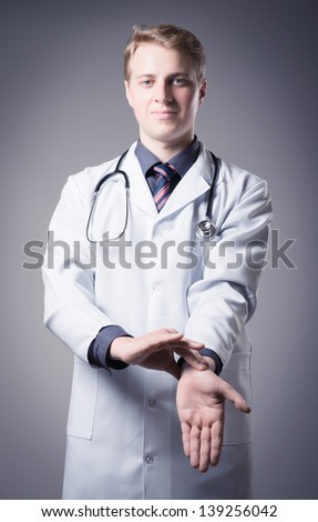 young doctor measures the heart rate itself