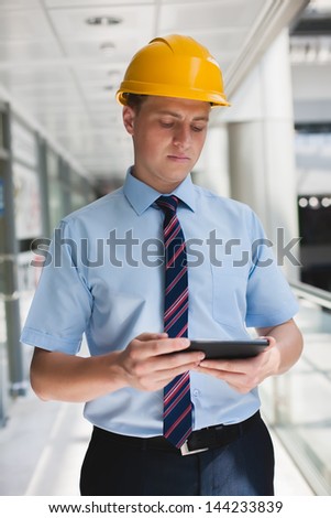 engineer in a helmet with a digital tablet