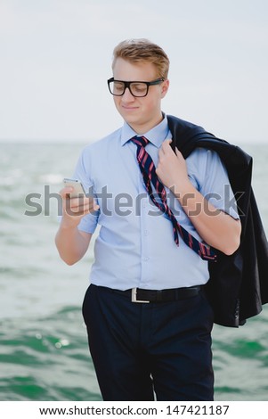 successful young businessman with phone