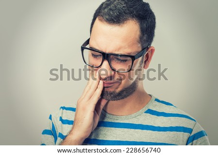 Young man in glasses covered her mouth