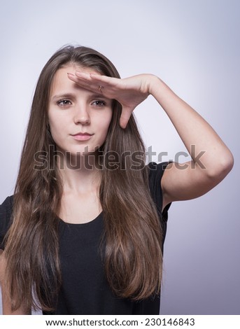 Woman with hand on forehead looking into distance