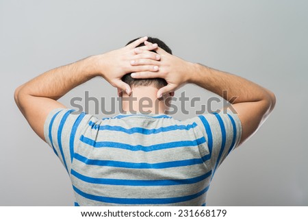 Depressed young man  holding head in hands
