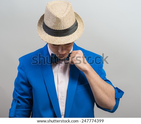stylish guy in the hat and blue jacket dresses butterfly