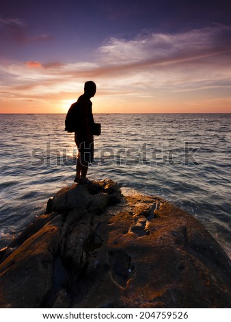 Silhouette of a single man watching the sunset