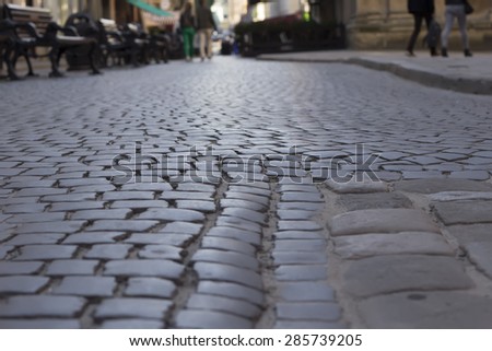 Lviv, Ukraine-June 6, 2015: Tourists walk on the pavement in the center of the ancient city.Lvov is one of the most popular cities for tourism in Ukraine.