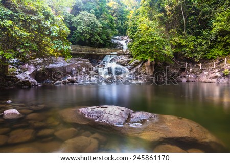 Langsir waterfall at kenyir lake.    Image has grain or subject is blurry or noise or out of focus and soft focus when view at full resolution. (Shallow DOF, slight motion blur)
