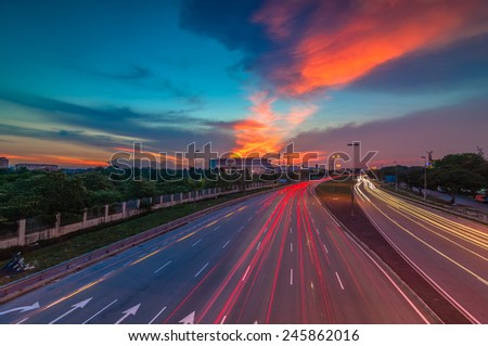 Light trail and beautiful sunset.    Image has grain or subject is blurry or noise or out of focus and soft focus when view at full resolution. (Shallow DOF, slight motion blur)