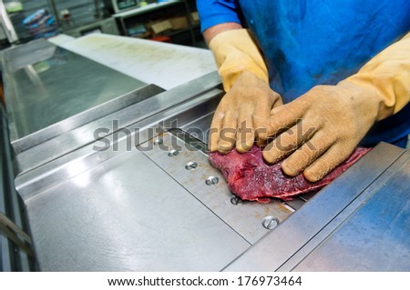 ostrich meat steak on the grinding machine