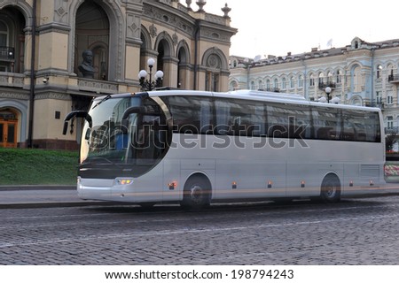 white tourist bus on a city block