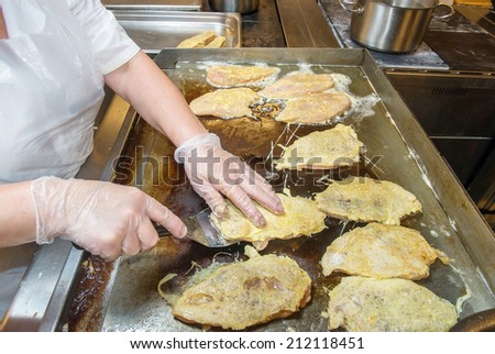 frying chicken in batter in a fast food restaurant