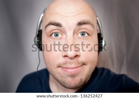 The young man listens to music in earphones