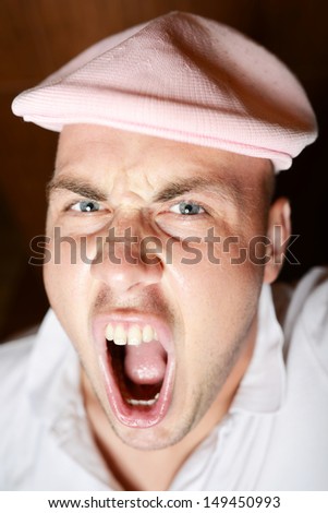 Angry young man screaming. emotion