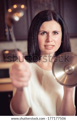 The angry housewife protects kitchen
