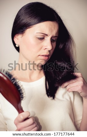 shocked girl looks at the cut tags of the hairs